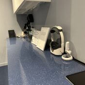 Eye exam equipment and diploma on an optometry office counter.