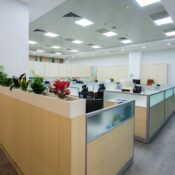 Clean, bright open office with cubicles, planters, and ceiling vents, ready for a commercial cleaning checklist before winter